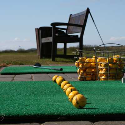 Line of golfballs waiting to be hit